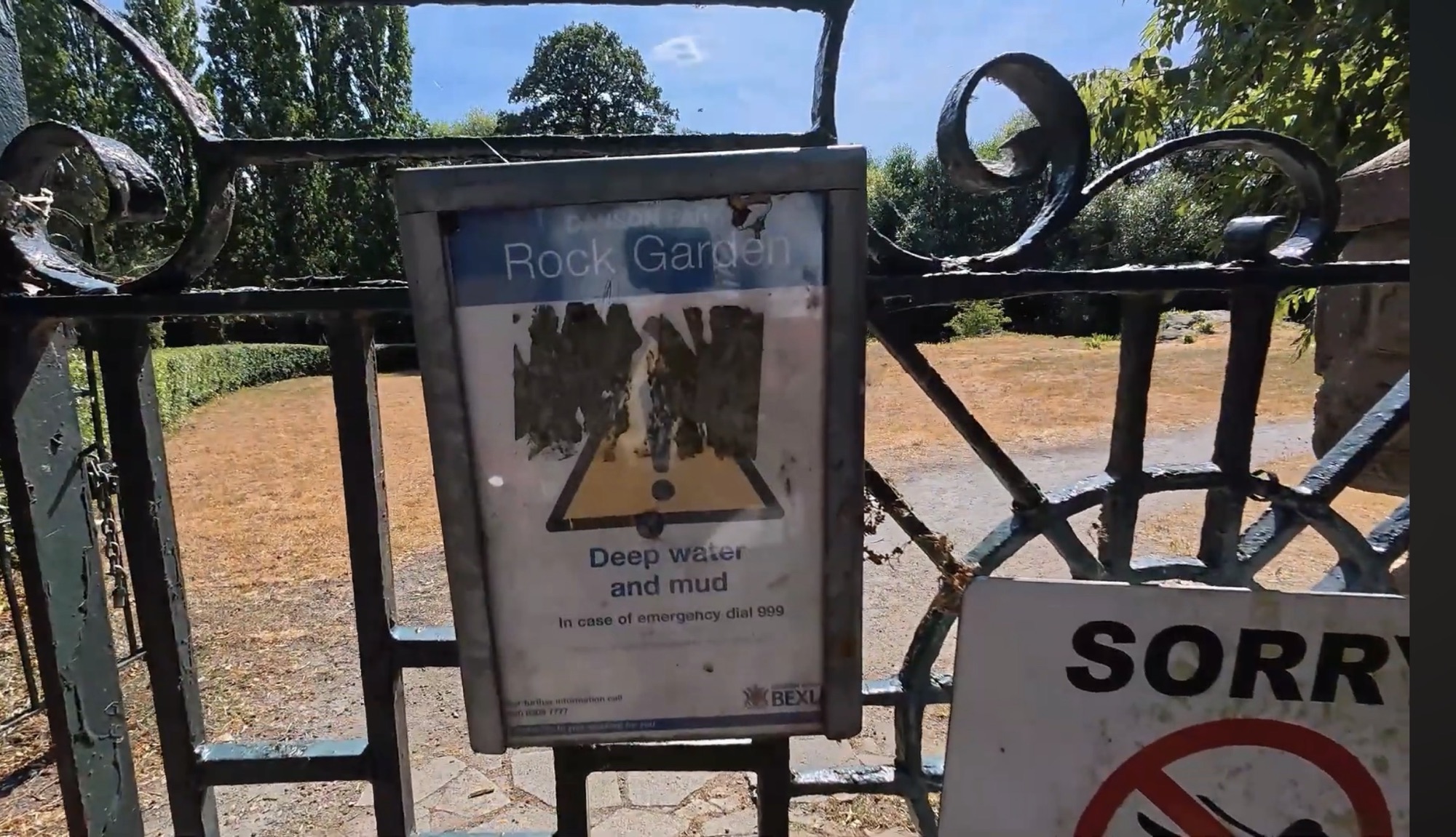 Locked gates to the Danson Park Rock Garden with closure and deep water warning notices