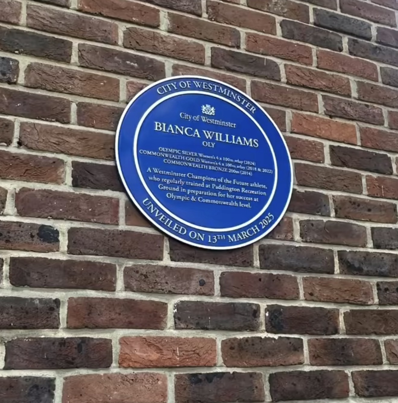 Sir Roger Bannister blue plaque at Paddington Recreation Ground marking where he trained for the four-minute mile