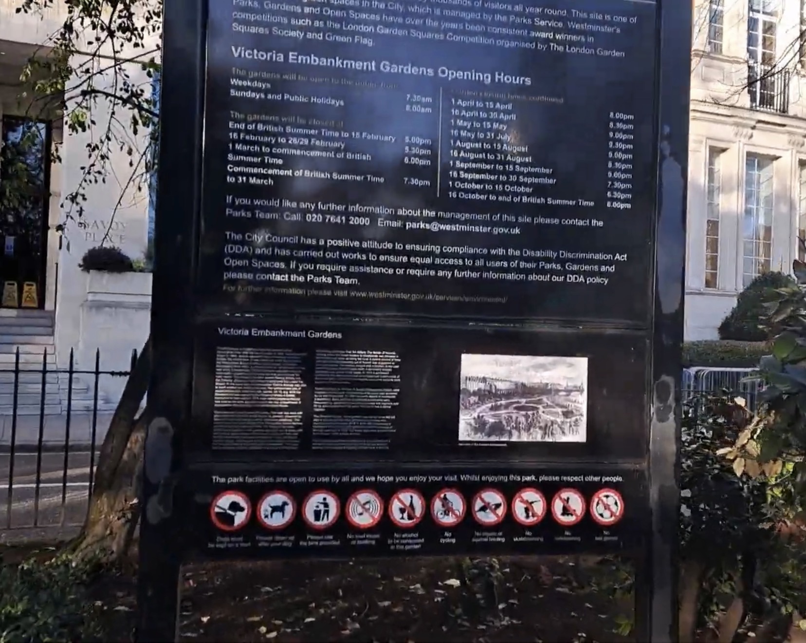 Notice board showing the Victoria Embankment Gardens opening hours table and an old engraving of the gardens