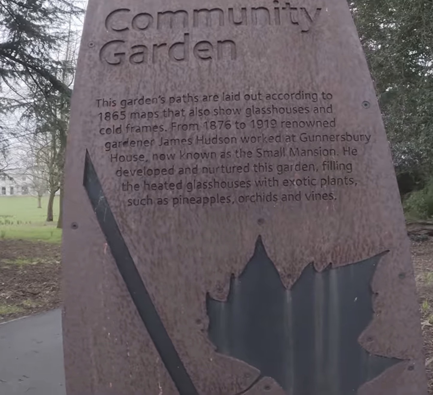 Community Garden sign describing gardener James Hudson and the glasshouses at the Small Mansion