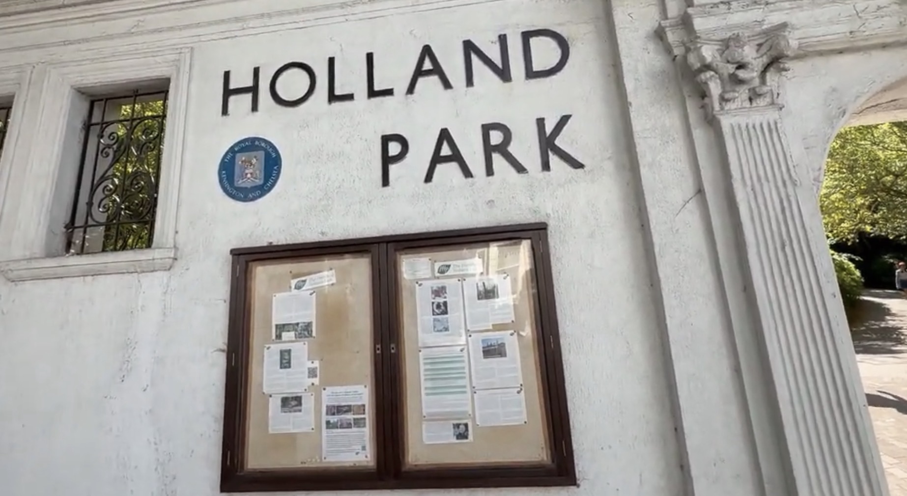 Holland Park name carved on the wall above the notice board at the Kensington High Street entrance