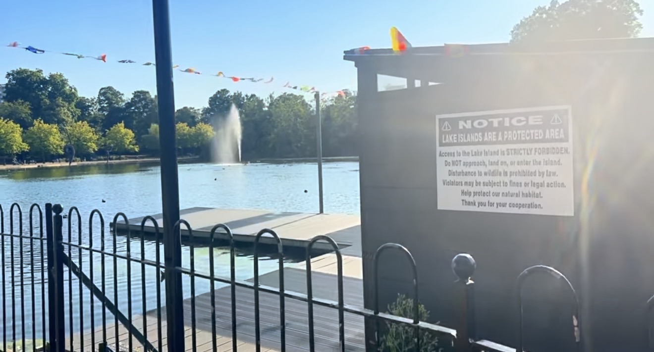 The West Boating Lake with its fountain and a sign warning the island is a protected area
