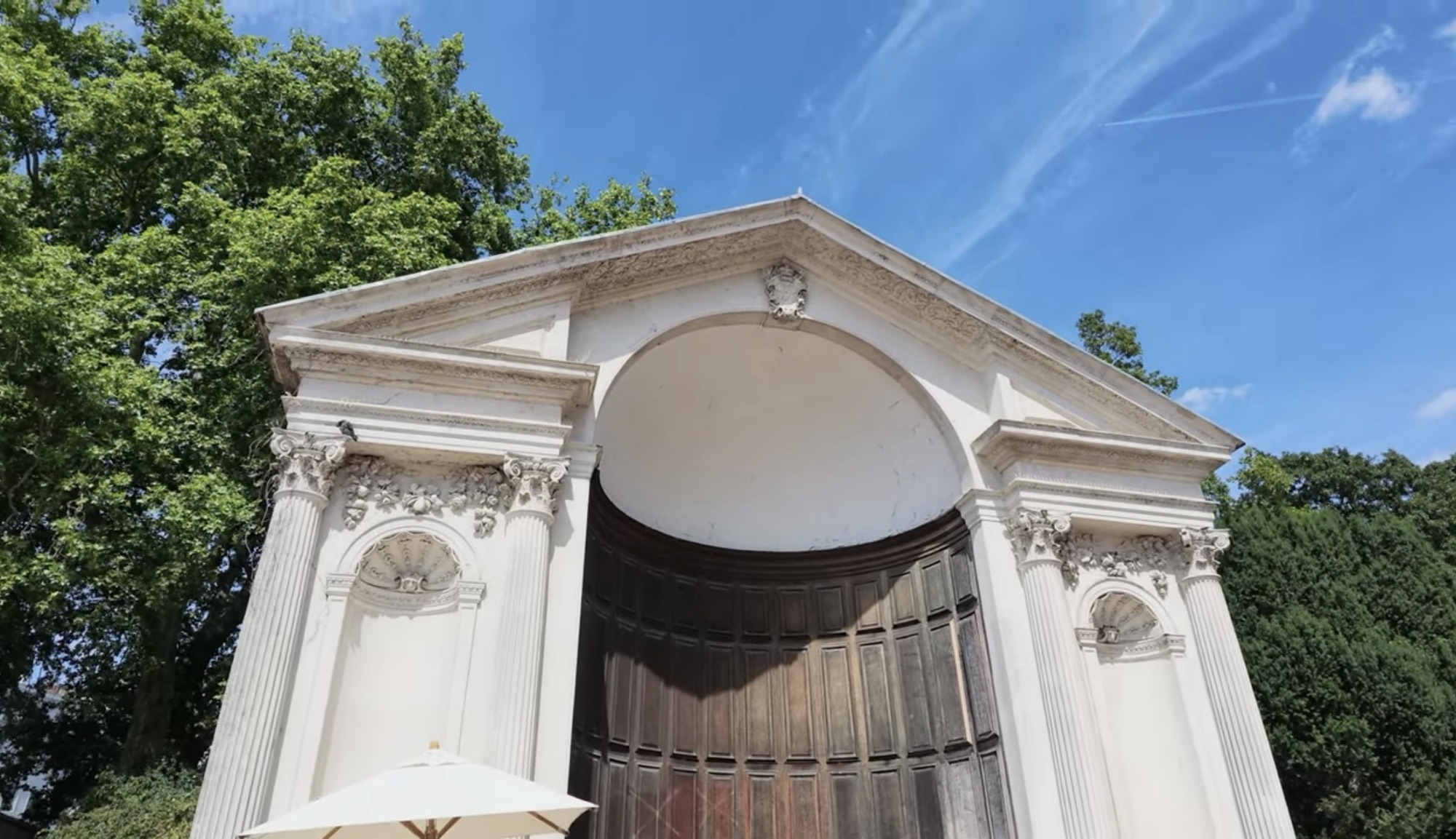 Close-up of the carved pediment and arched doorway on the Italian Gardens pump house building