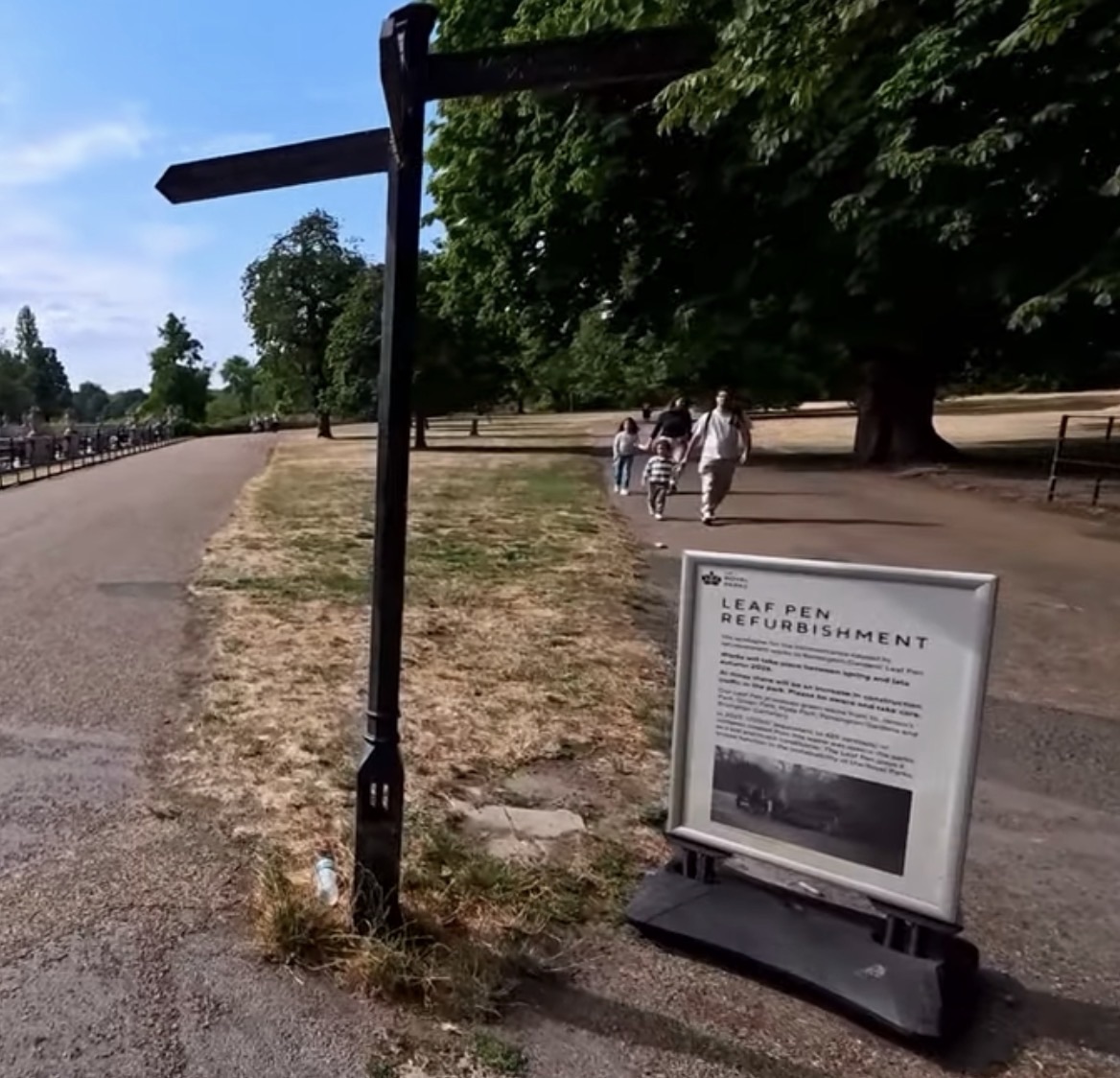 Leaf Pen Refurbishment notice board standing beside a Victorian fingerpost in Kensington Gardens