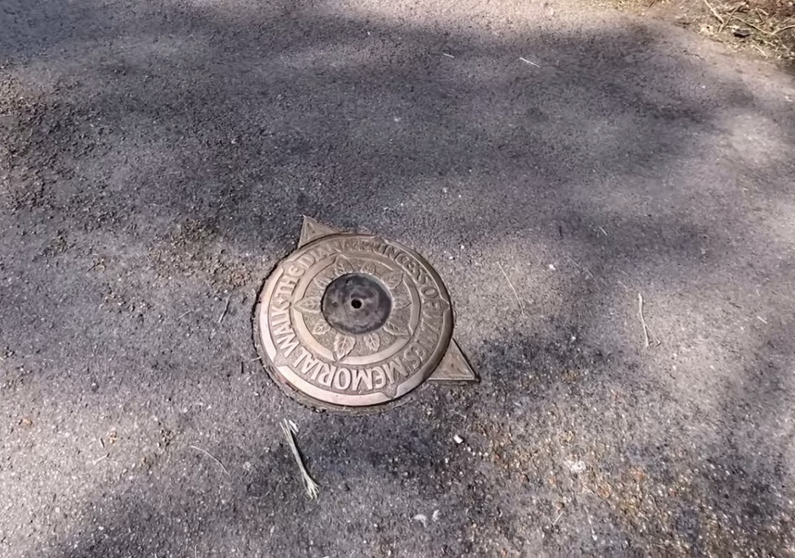 Bronze marker set into the tarmac path reading Diana, Princess of Wales Memorial Walk