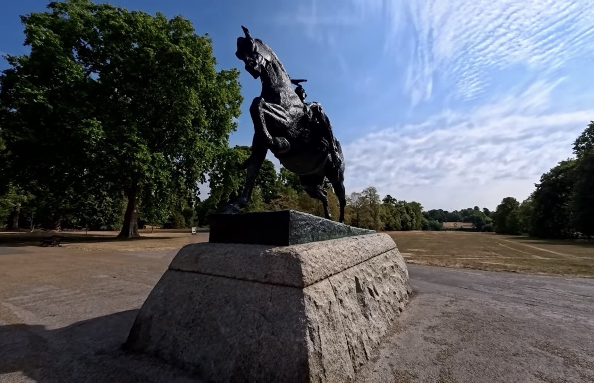Physical Energy, G. F. Watts's bronze of a rearing horse and rider, seen from behind on its granite plinth in Kensington Gardens