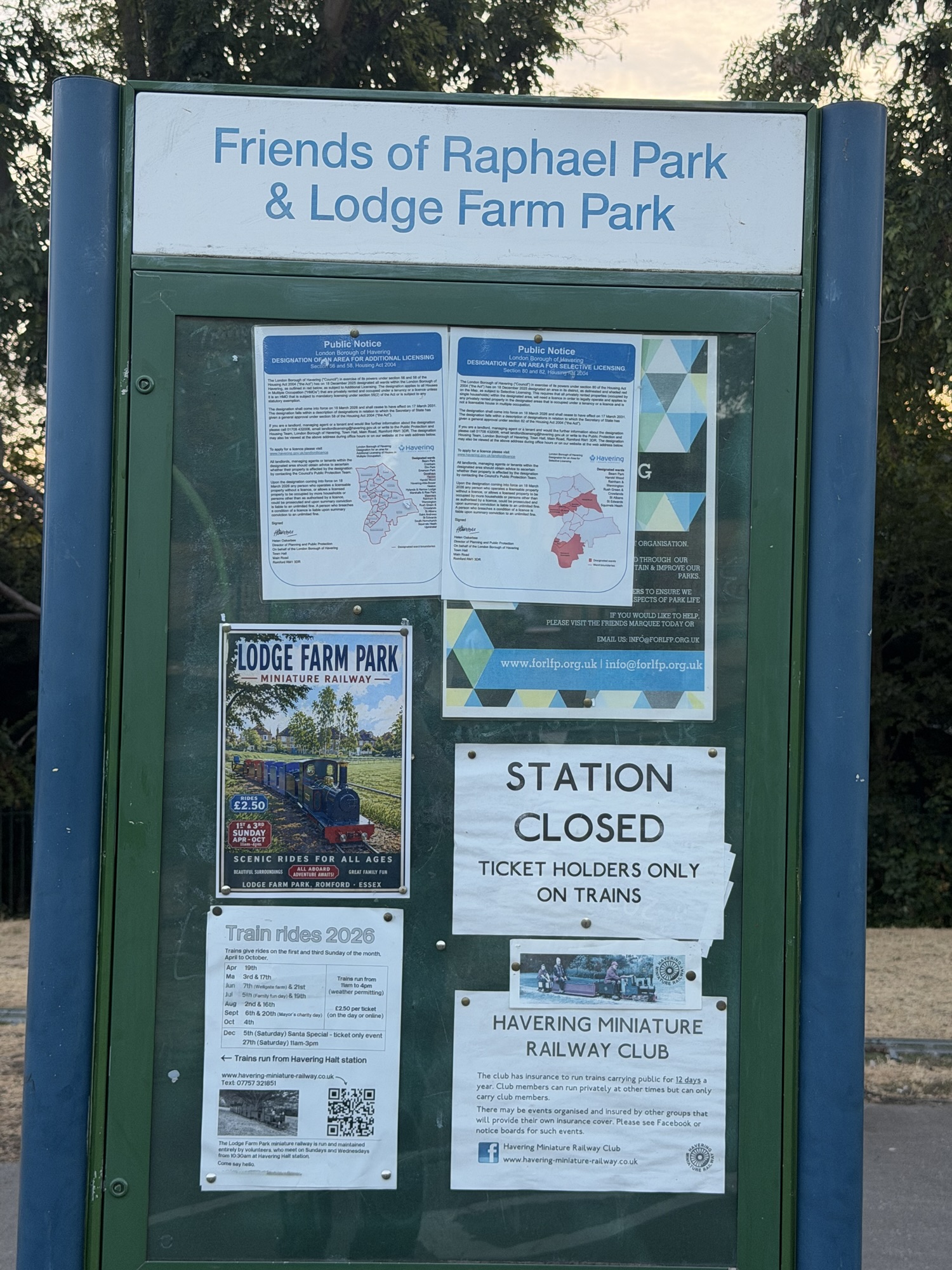 Friends of Raphael Park and Lodge Farm Park noticeboard with miniature railway posters and train ride dates
