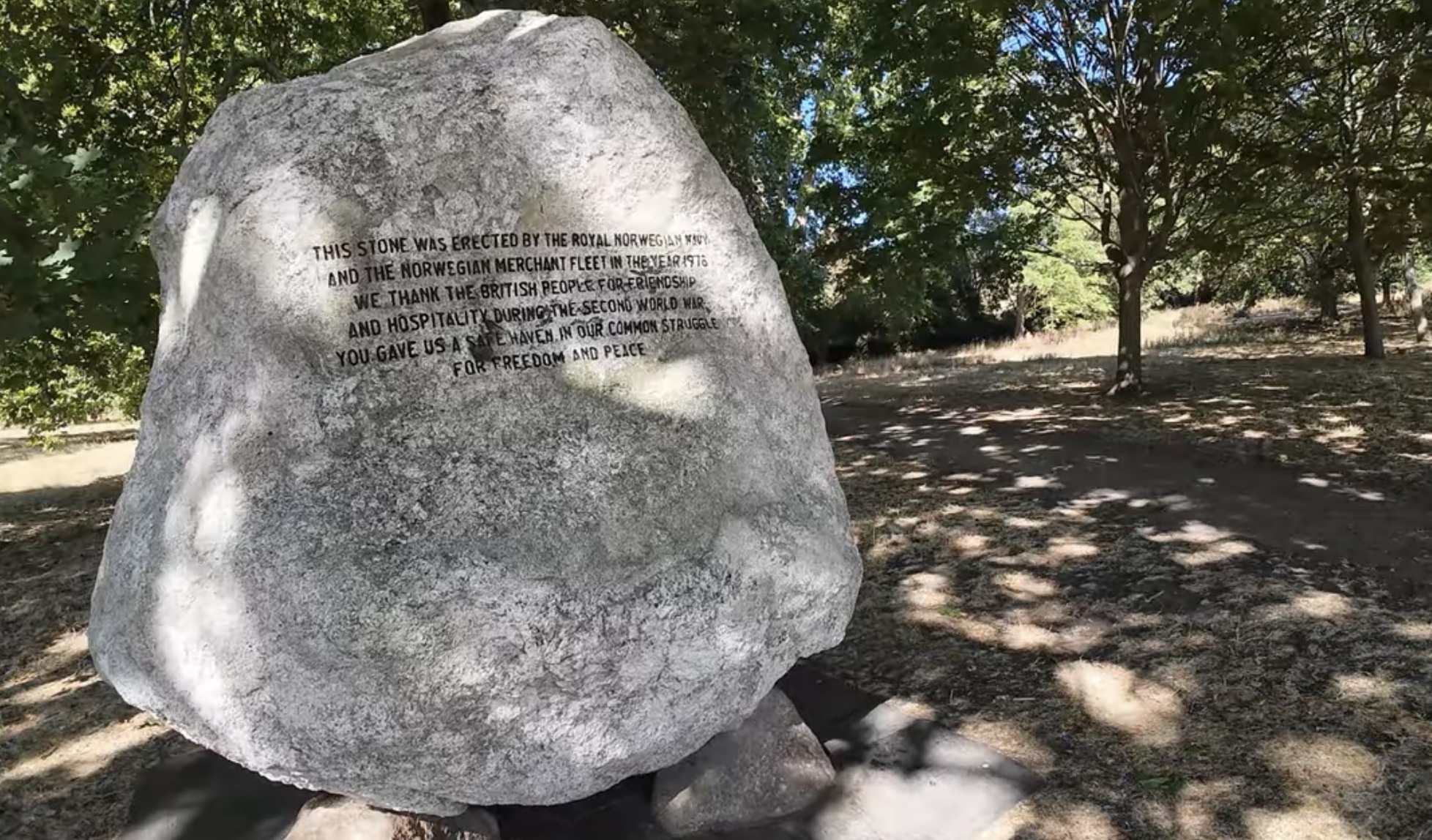 The Norwegian Navy memorial stone in Hyde Park, a large boulder with an engraved inscription, set among trees