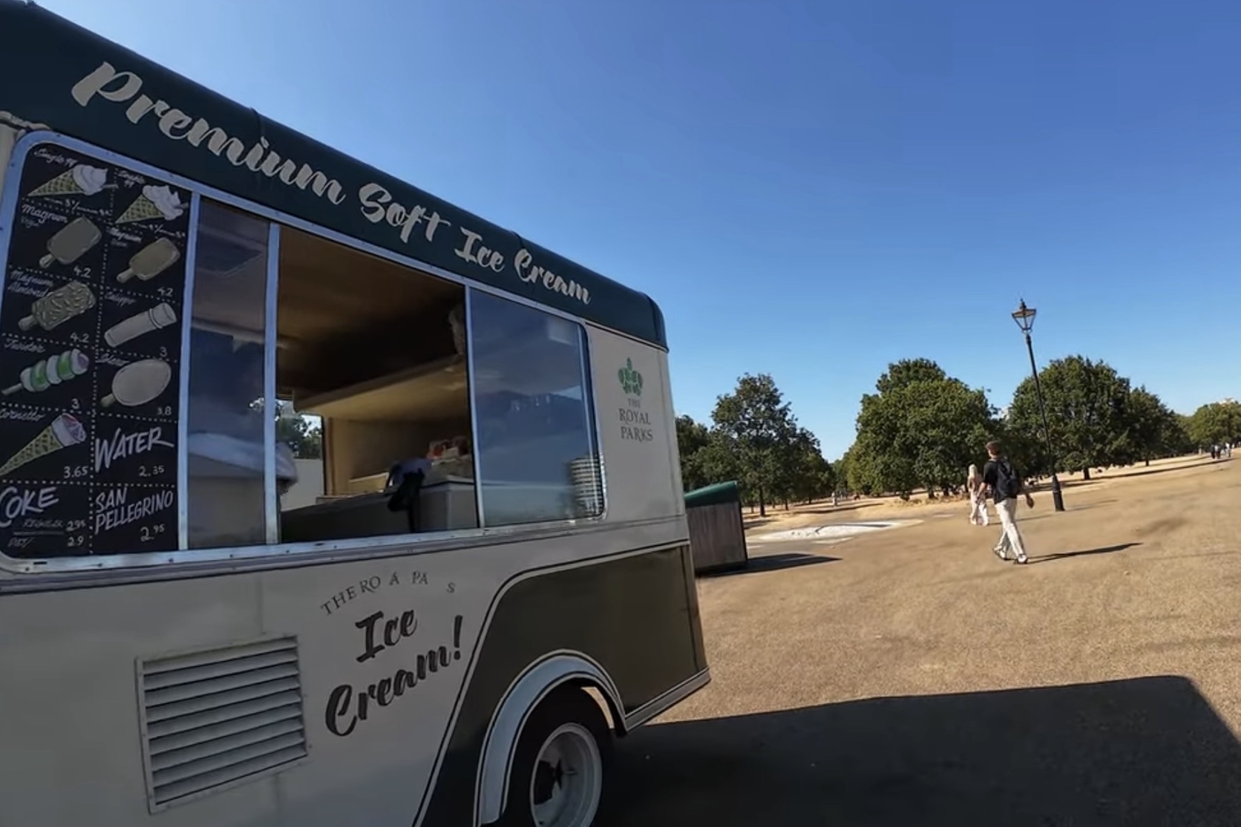 Classic-style Royal Parks ice cream van with a Premium Soft Ice Cream menu, parked on a sunny path in Hyde Park