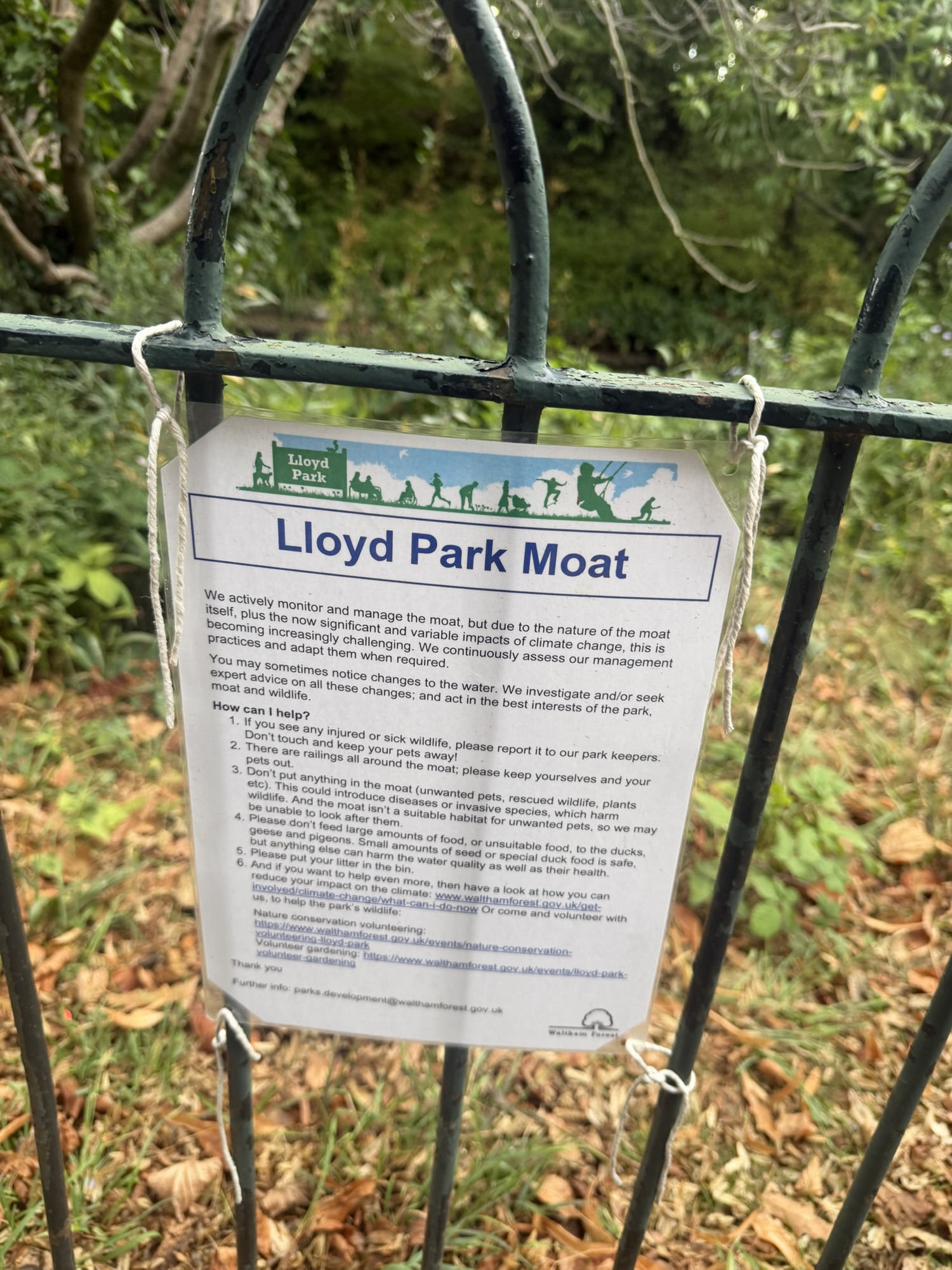 Lloyd Park Moat information sign fixed to the railings explaining how the moat is managed