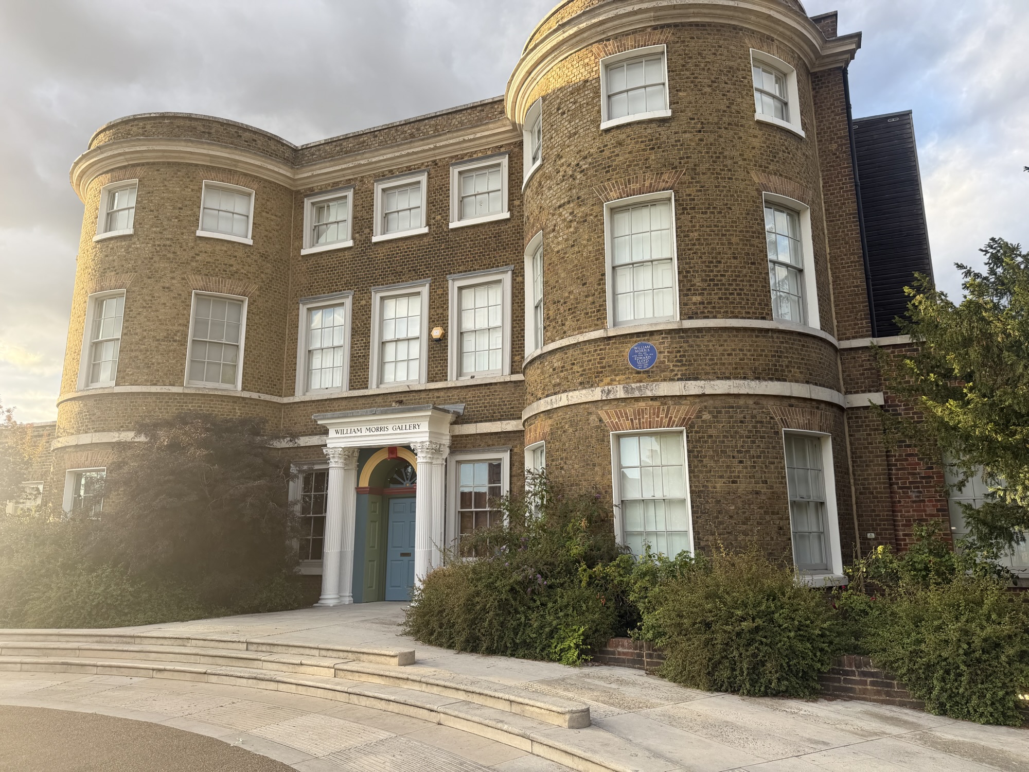 The William Morris Gallery building exterior in Lloyd Park, a brick house with curved bay windows