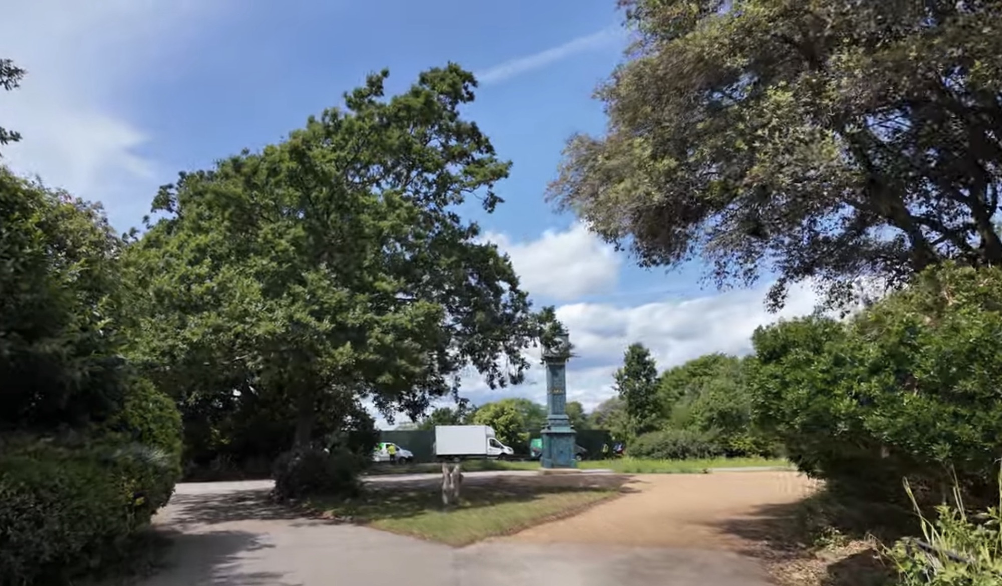 Path leading towards the historic clock tower monument in Brockwell Park