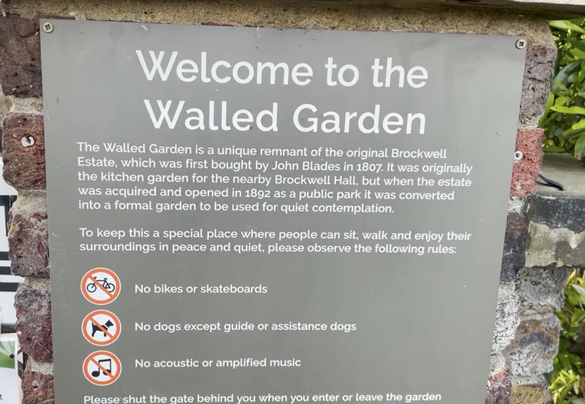 Welcome to the Walled Garden sign at Brockwell Park explaining its history since 1807 and listing visitor rules