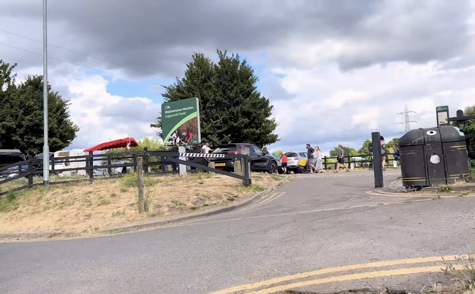 Entrance to Walthamstow Marshes Coppermill Fields with visitors and parked cars
