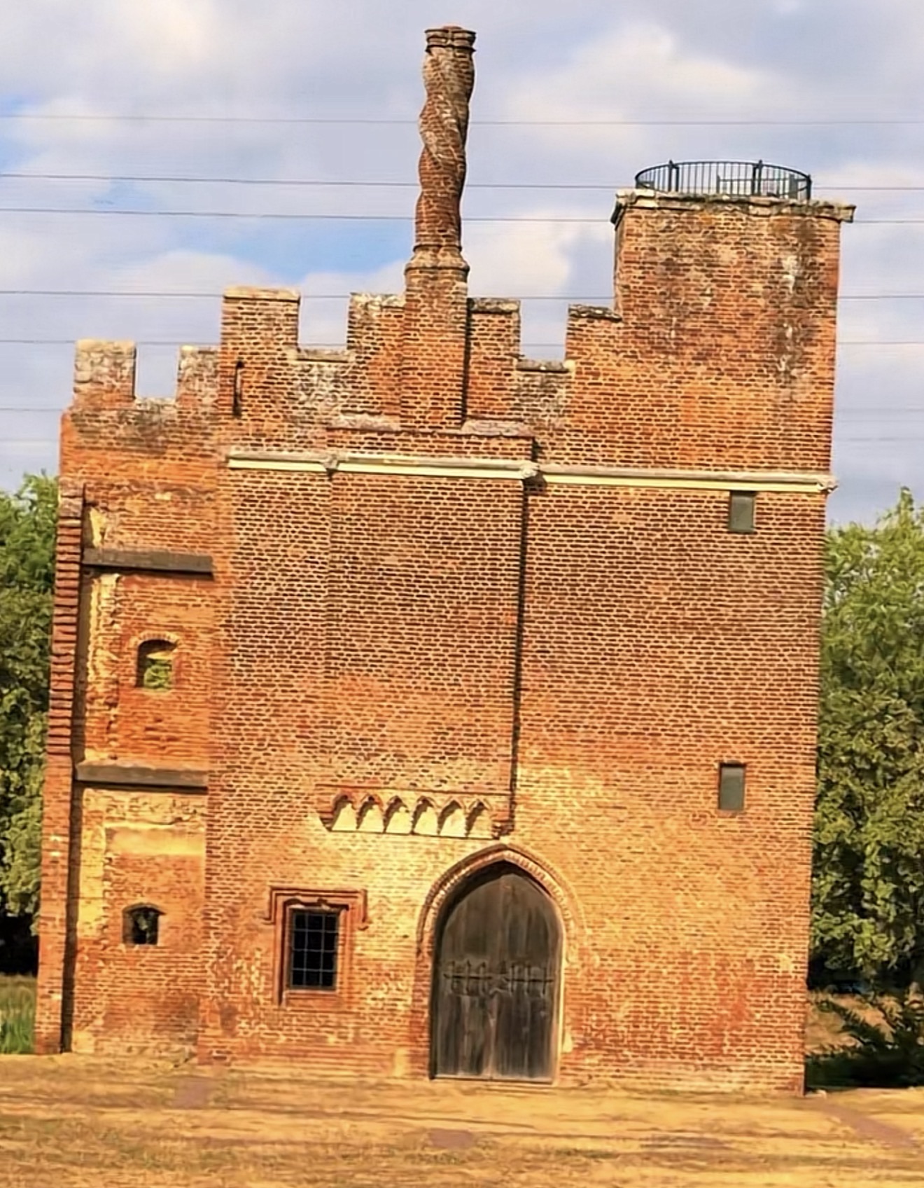 Crenellated red brick gatehouse with a twisted chimney near Lee Valley