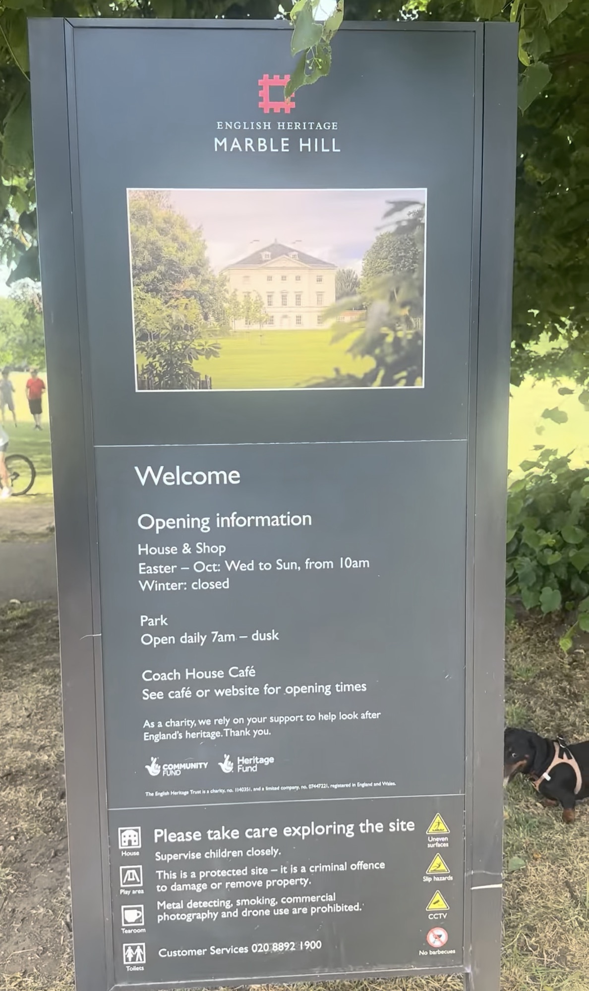 English Heritage Marble Hill welcome sign showing opening times for the house, park and Coach House caf&eacute;