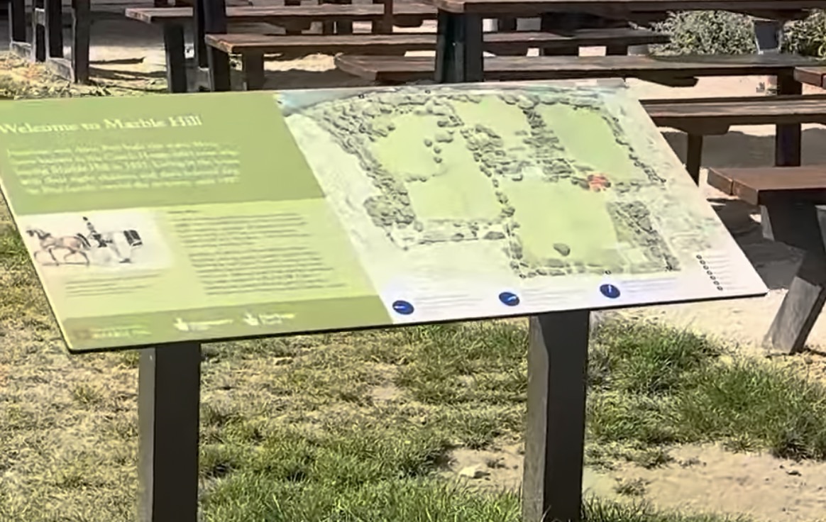 Welcome to Marble Hill information board with a map of the grounds and grazing horses