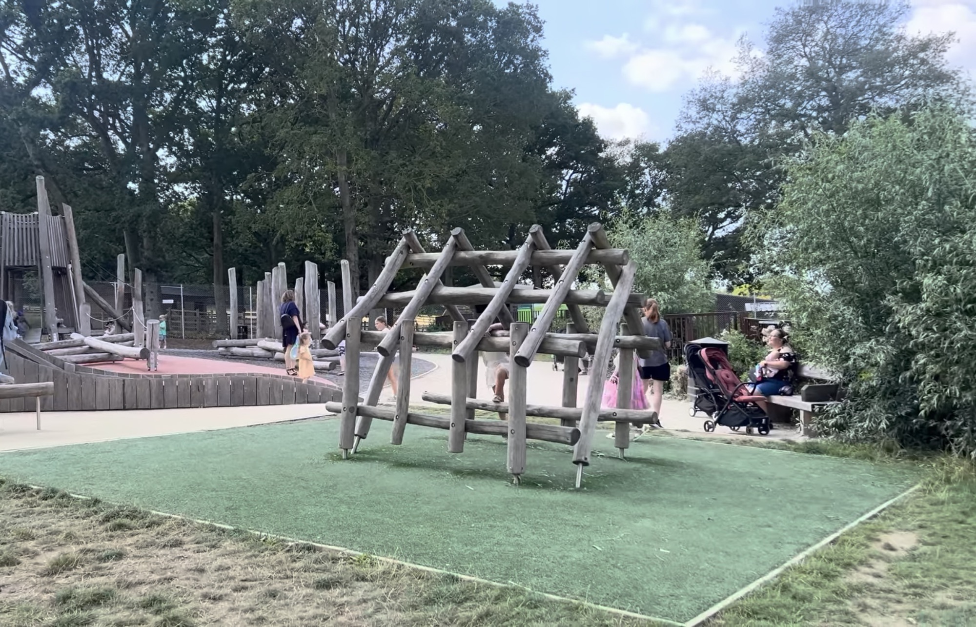 Wooden climbing frames and play structures in the adventure playground at Hainault Forest Country Park