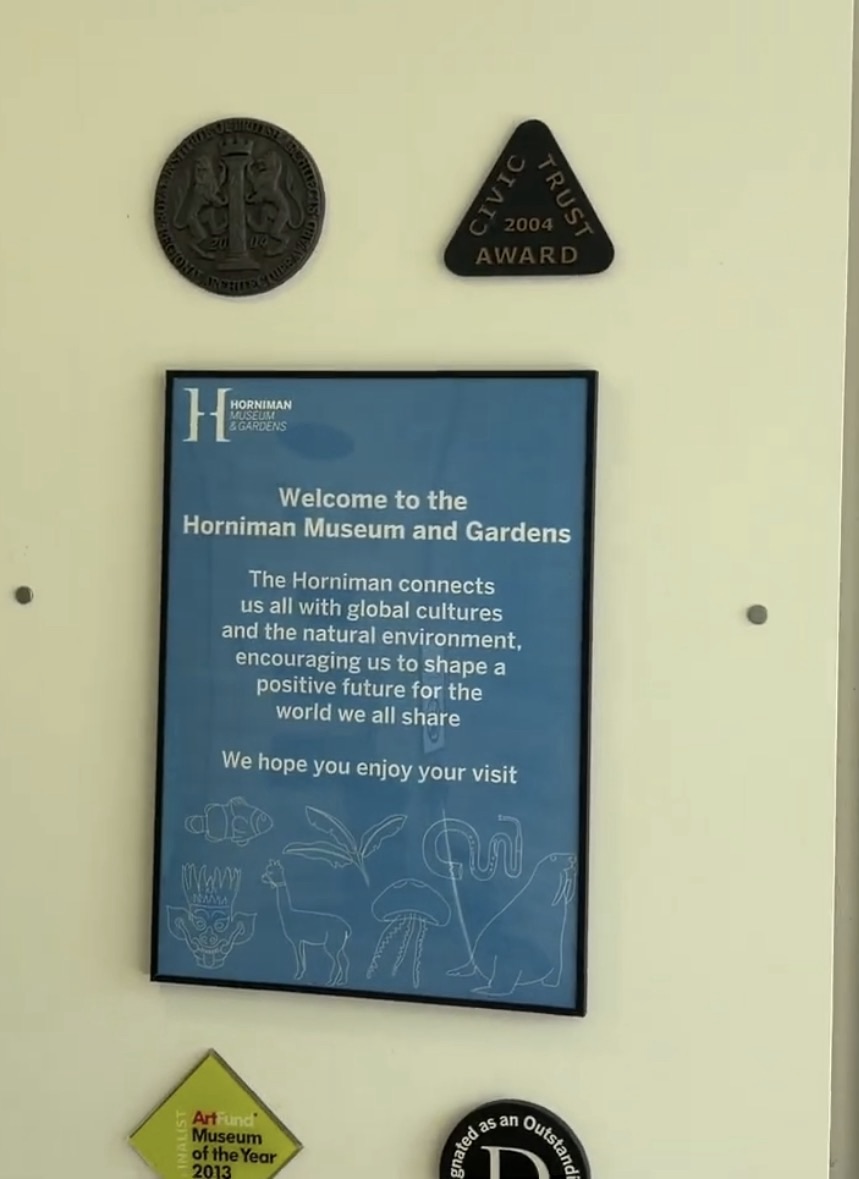 Welcome sign inside the Horniman Museum and Gardens beside a Civic Trust 2004 award plaque